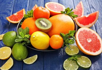 Juicy composition of tropical fruits in a bowl, close up